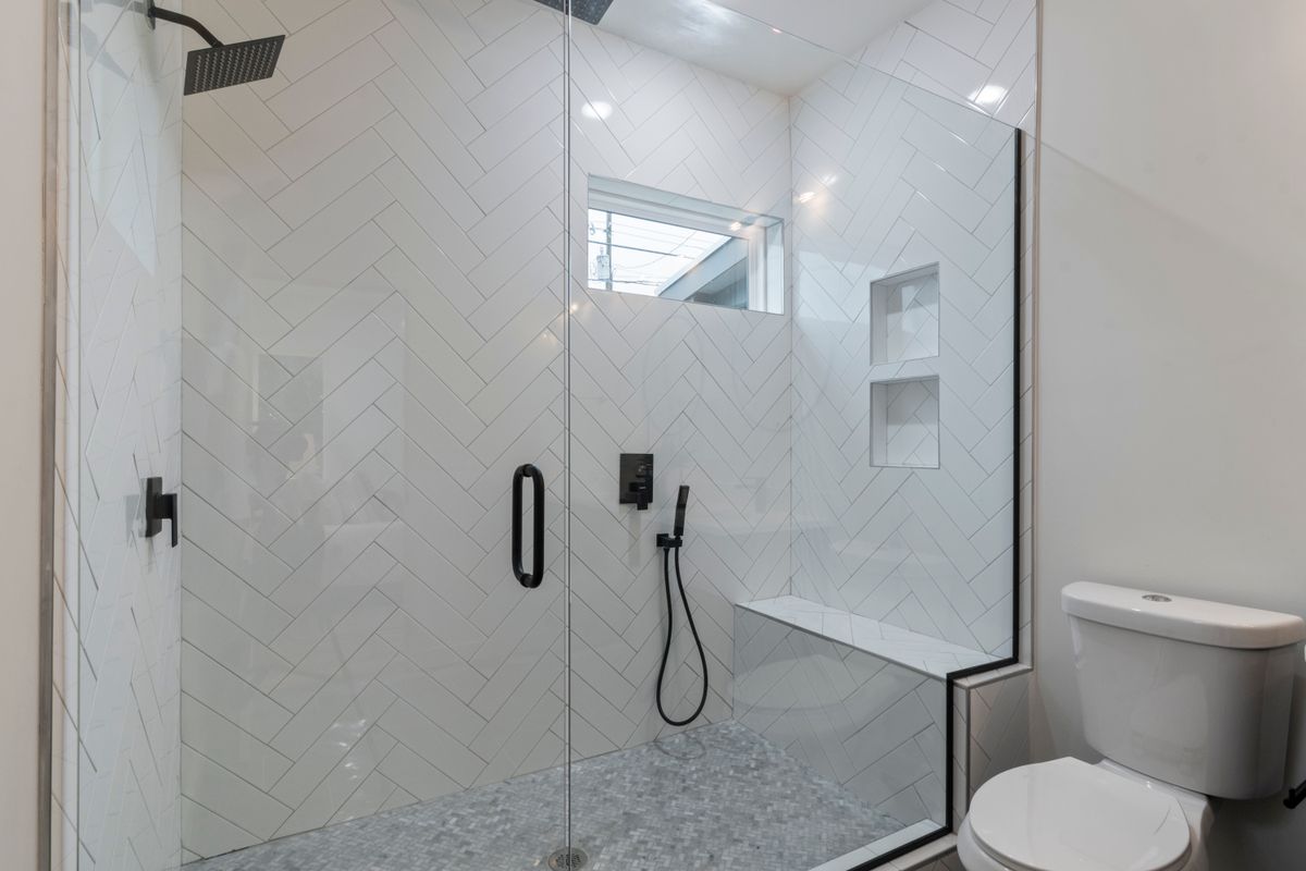 Accessible curbless shower with a bench seat