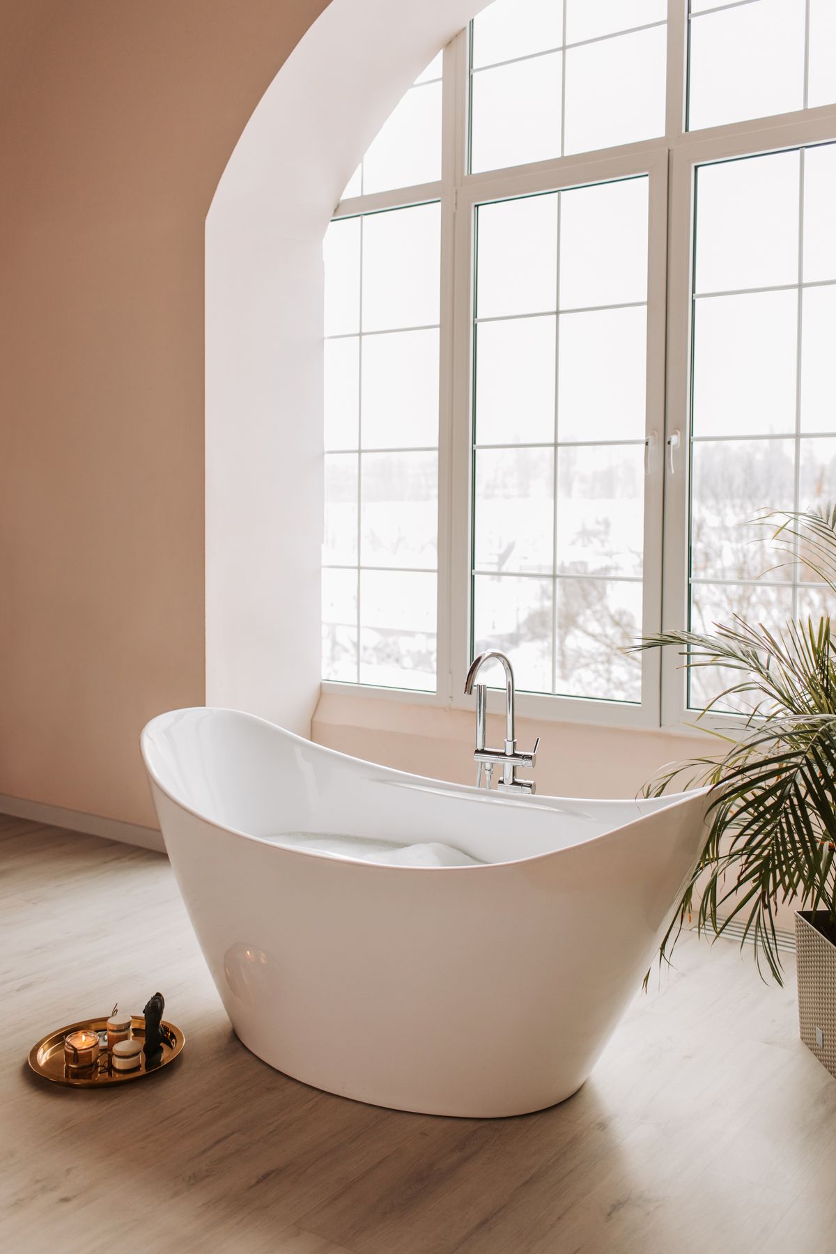 Freestanding soaking tub in a bright bathroom