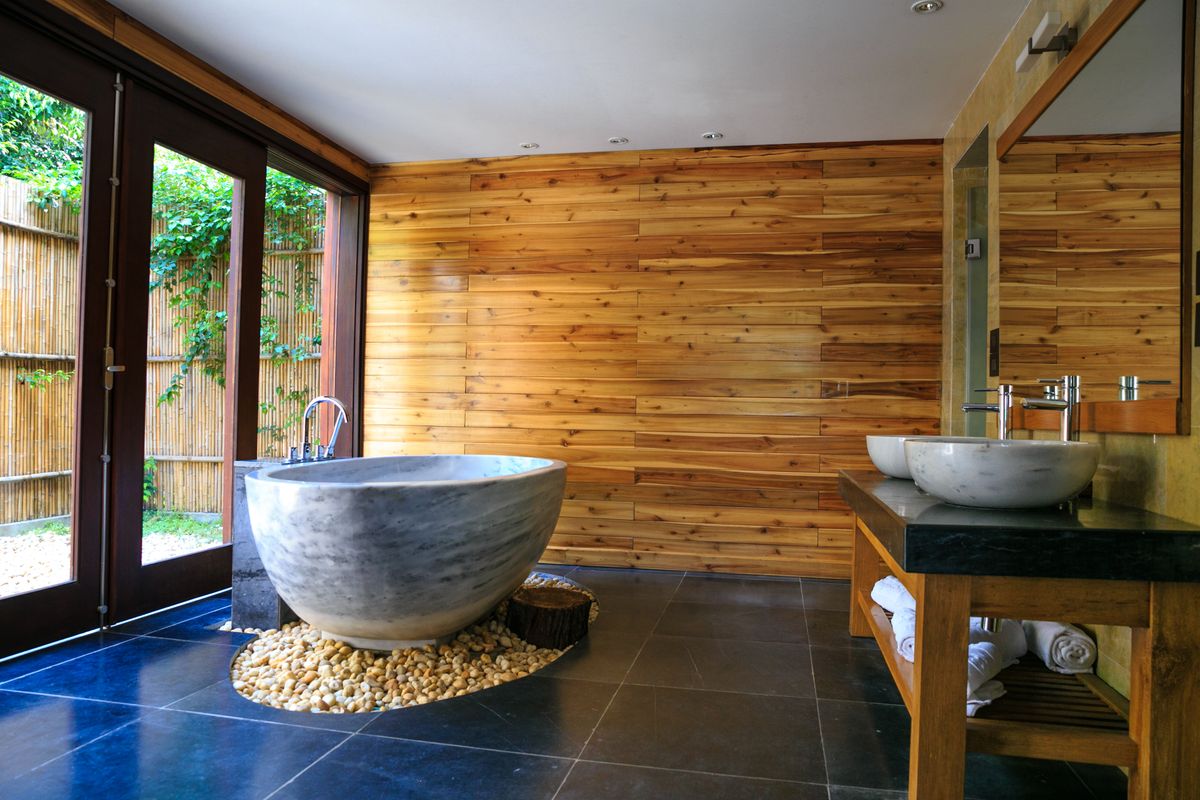 Warm, spa-like bathroom with natural wood and stone