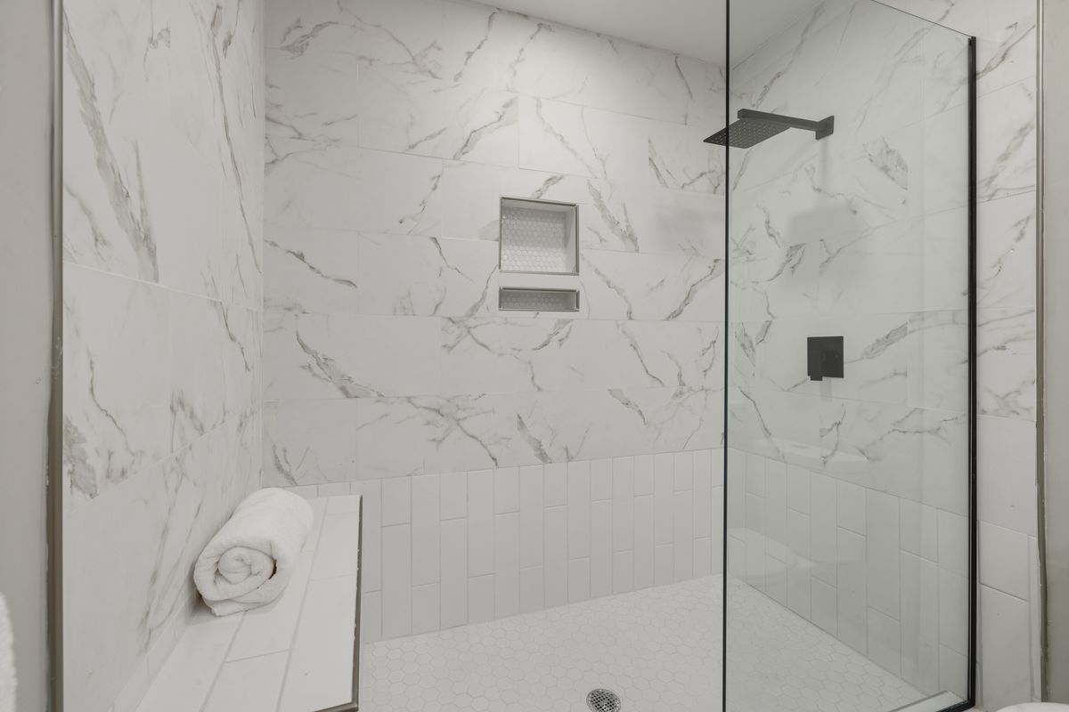 Curbless walk-in shower with frameless glass in a modern bathroom