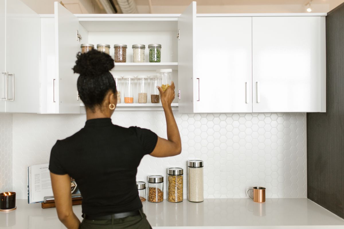 Organized kitchen cabinet storage with glass pantry jars
