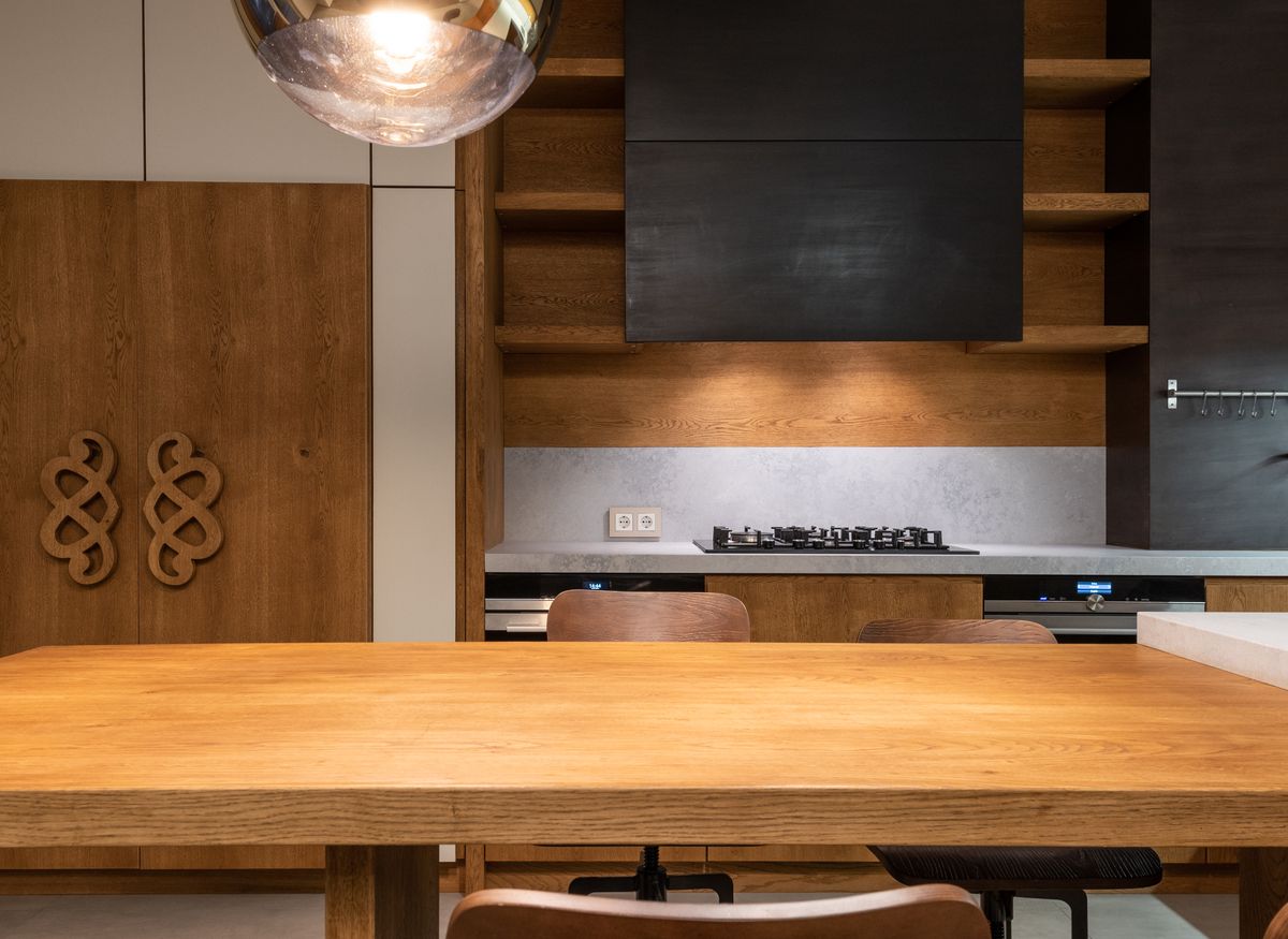 A warm, wood-toned modern kitchen with natural cabinetry