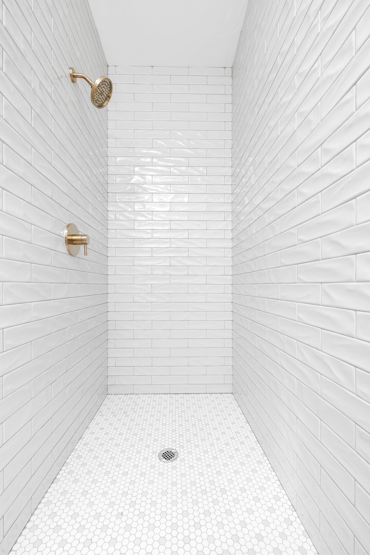 White subway tile and a hexagon-tile floor, finishes that suit an older home