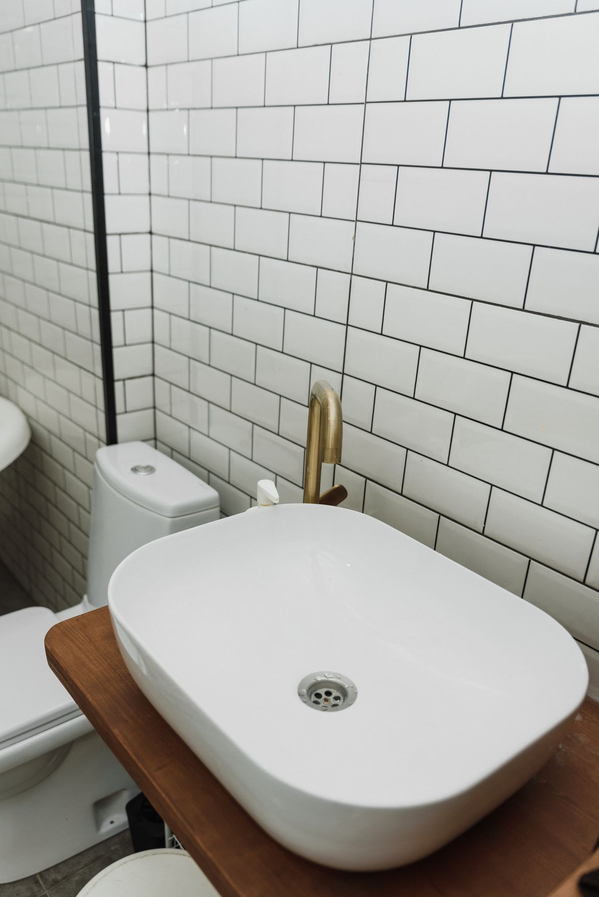 White subway tile with a brass faucet, a timeless older-home look